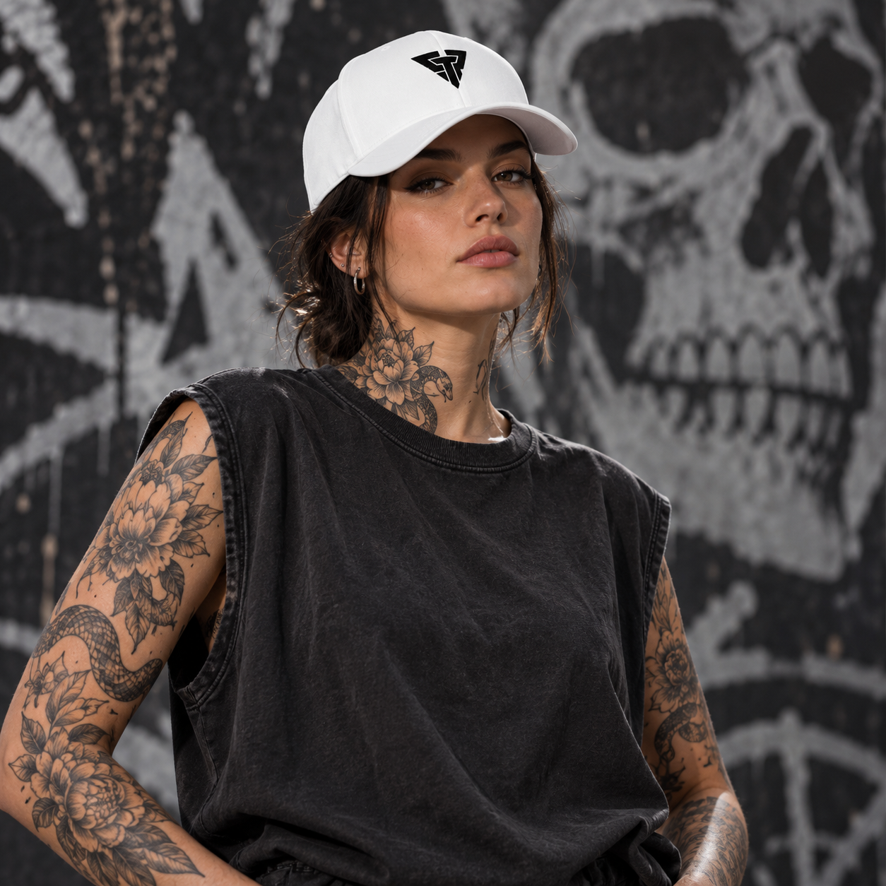 Woman wearing the white CPT Onyx Cap in front of a graffiti skull wall